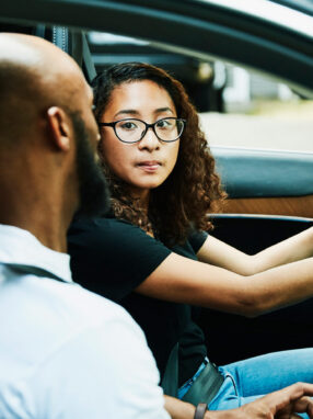 A person and person in a car Description automatically generated with medium confidence